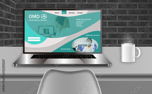 Laptop on a desk with web designs on the screen