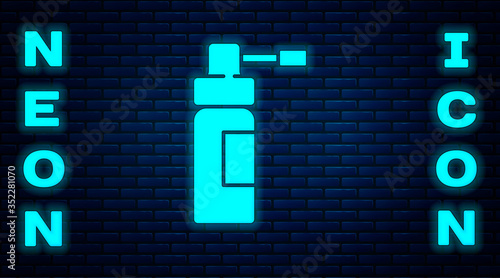 Glowing neon Medical bottle with nozzle spray for the treatment of diseases of the nose and throat icon isolated on brick wall background. Vector