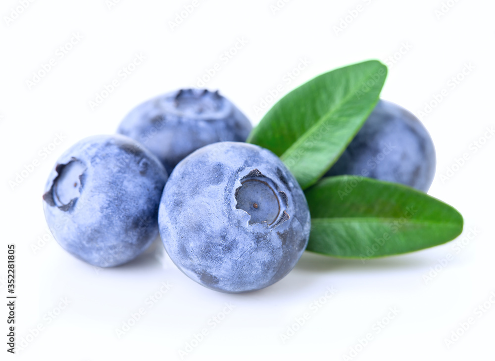 Ripe juicy blueberries with leaves isolated on a white background. Ripe juicy blueberries with leaves isolated on a white background.