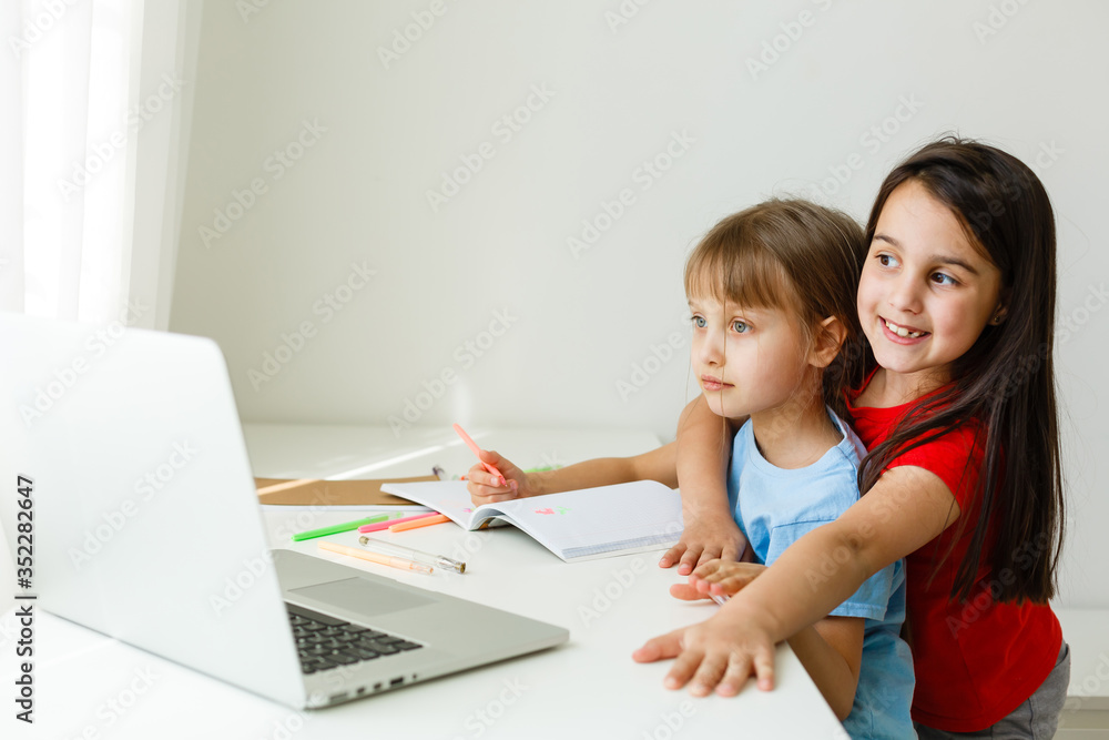 Pretty stylish schoolgirls studying math during her online lesson at home, social distance during quarantine, self-isolation, online education concept Pretty stylish schoolgirls studying math during her online lesson at home, social distance during quarantine, self-isolation, online education concept