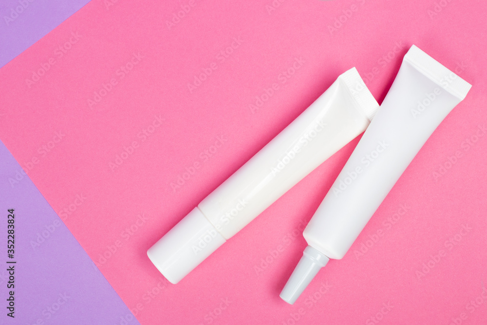 Cosmetic tube mock up isolated on pink background. Lotion skin care bottle template. Beauty concept. Cosmetic tube mock up isolated on pink background. Lotion skin care bottle template. Beauty concept.