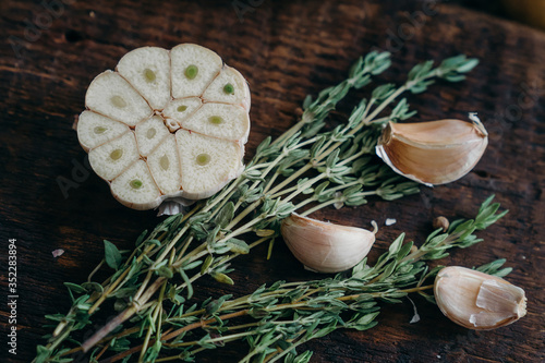 Thyme,  garlic on a brown wooden board. farm products, organic products, Healthy food concept