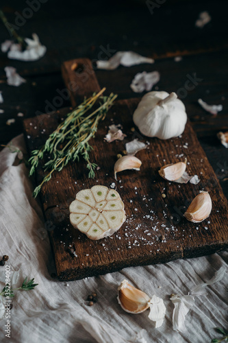 Thyme,  garlic on a brown wooden board. farm products, organic products, Healthy food concept