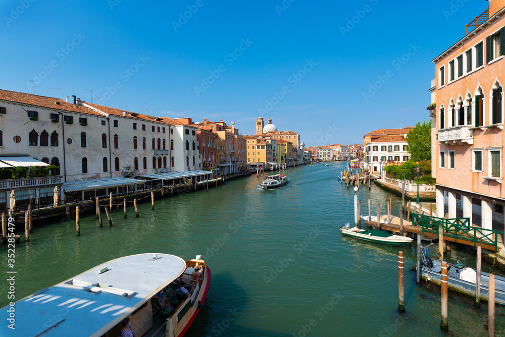 A sunny and truly peaceful afternoon on the Grand Canal. Panorama taken from the Ponte degli Scalzi in the direction of Rialto. The canal appears almost empty, few boats and very few tourists.