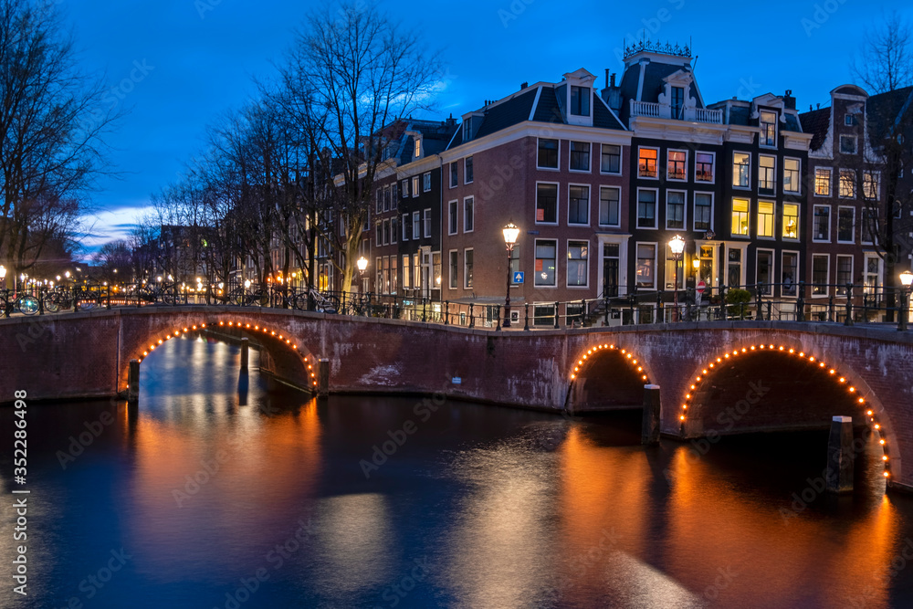 City scenic from Amsterdam at the canals in the Netherlands at night