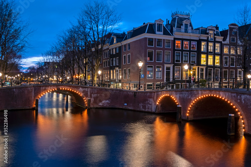 City scenic from Amsterdam at the canals in the Netherlands at night