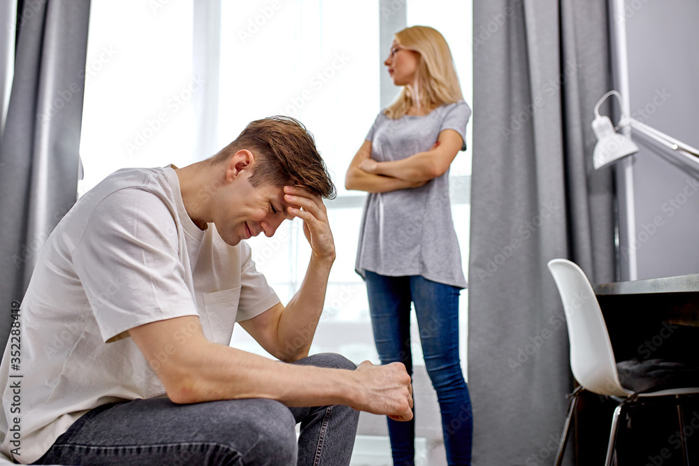 Fototapeta premium lovely young caucasian married couple have emotional quarrel at home in the morning, they didn't share something, their opinions do not coincide