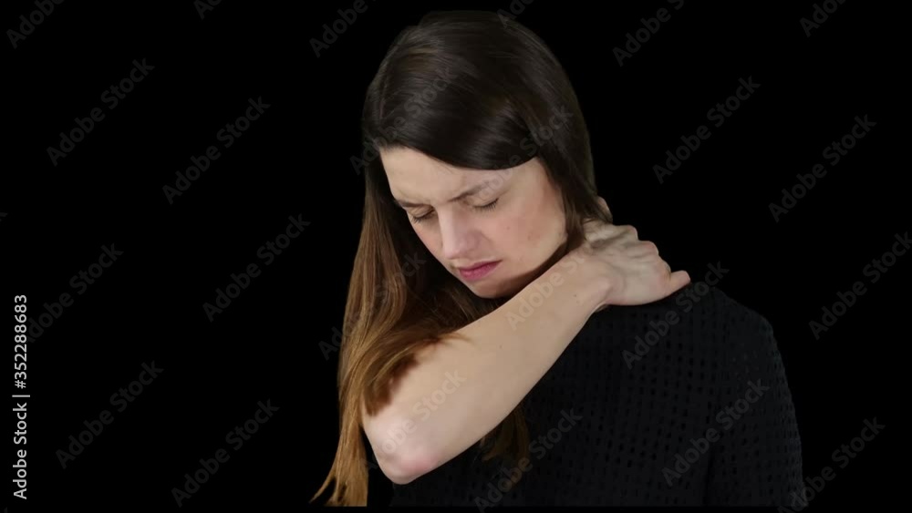 Junge Frau hat Schulterschmerzen. Sie massiert ihre Schulter mit der Hand. Junge Frau hat Schulterschmerzen. Sie massiert ihre Schulter mit der Hand.