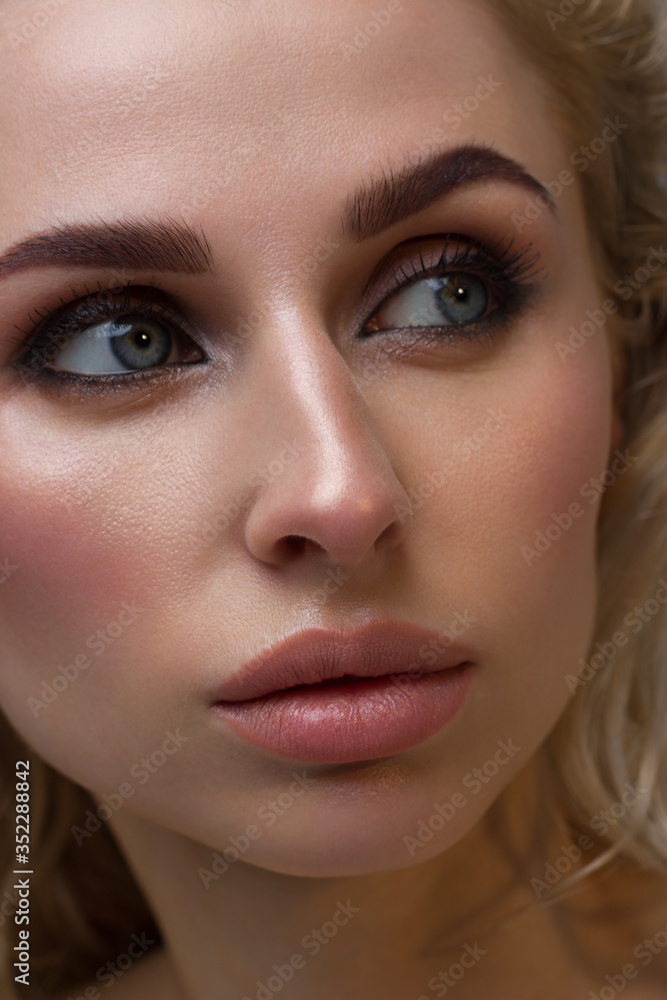 Close-up of woman's lips with fashion natural beige lipstick makeup. Macro sexy pale lipgloss make-up . Gentle pure skin and wavy blonde hair. Cosmetology, Spa, increase in lips Close-up of woman's lips with fashion natural beige lipstick makeup. Macro sexy pale lipgloss make-up . Gentle pure skin and wavy blonde hair. Cosmetology, Spa, increase in lips