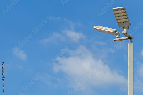 LED illuminated pole with a background of blue sky and clouds and copy space