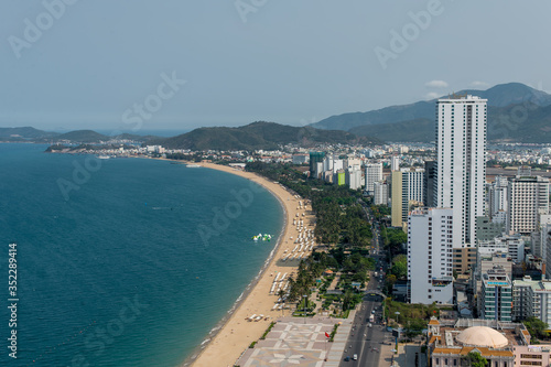 top view of the city with a promenade and beach, sea, hills, mountains
