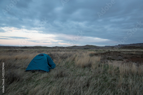 A backpacking tent set up in the backcountry wilderness of Badlands National Park in South Dakota.