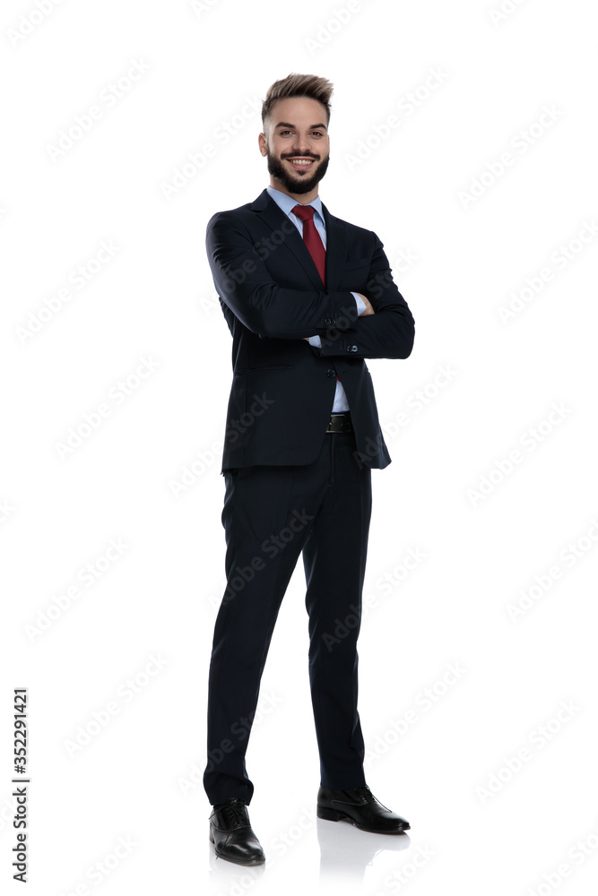happy young businessman crossing arms and smiling happy young businessman crossing arms and smiling