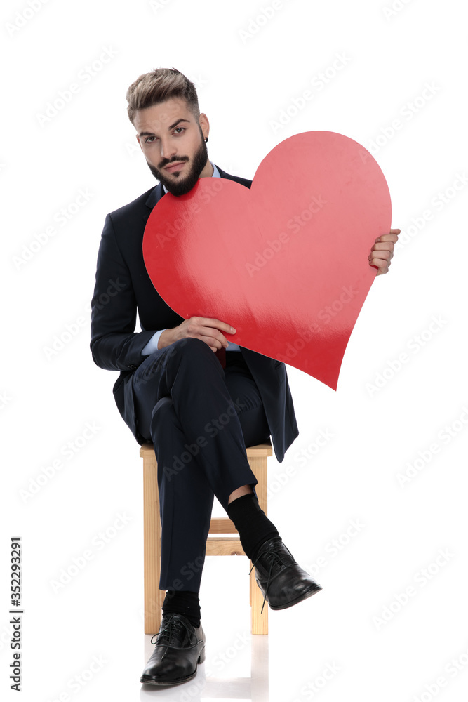 sexy young businessman holding big red heart sexy young businessman holding big red heart