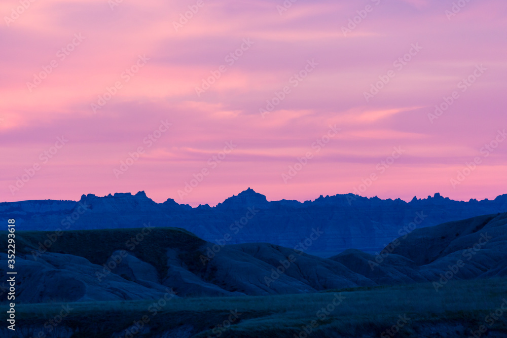 Landscape view of a colorful sunset in Badlands National Park in South Dakota).