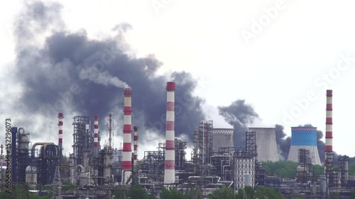 Strong fire at a petrochemical plant. Puffs of black smoke above the factory chimneys. Ecological catastrophe
