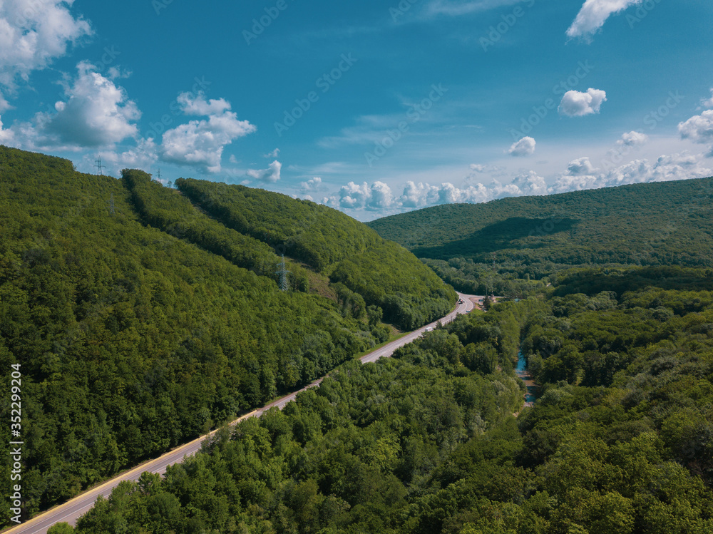 Aerial view of a rural highway between mountains