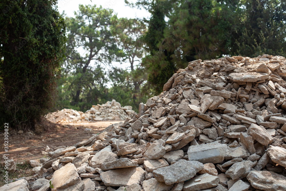 construction landfill in the forest, mountains of concrete stones, environmental pollution construction landfill in the forest, mountains of concrete stones, environmental pollution