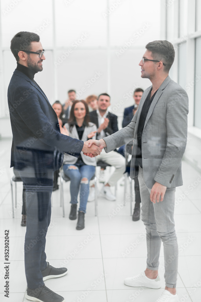 two intelligent business people standing in the conference room. two intelligent business people standing in the conference room.