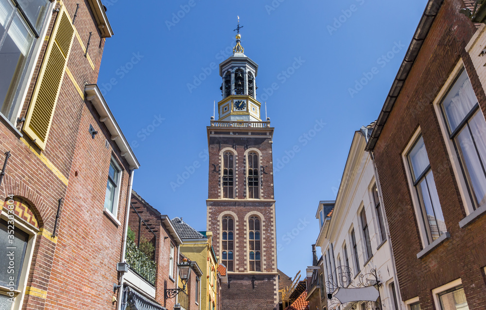 Street with old houses leading to the historic belfry of Kampen, Netherlands