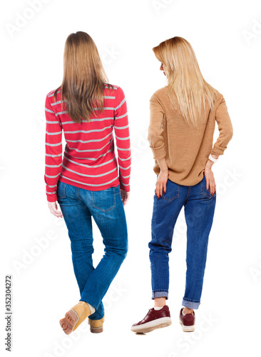 Back view of two woman in sweater.