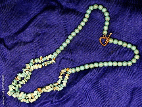 Female jewelry on a blue background. 