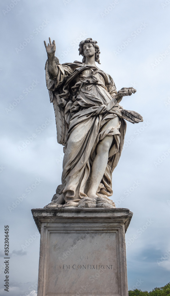 Fototapeta premium Full size ancient old statue of Angel with the Nails on Ponte Sant'Angelo in Rome near Castel Sant'Angelo