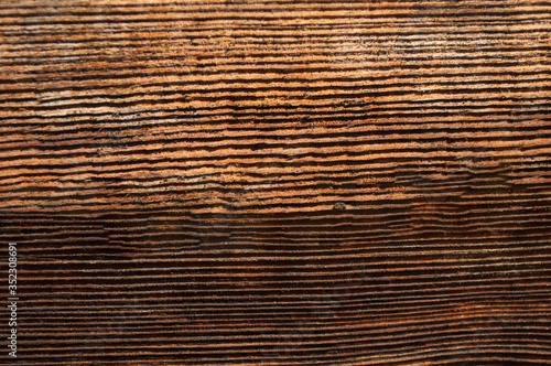 ?arts of a dark brown old wooden wall with a bright pattern