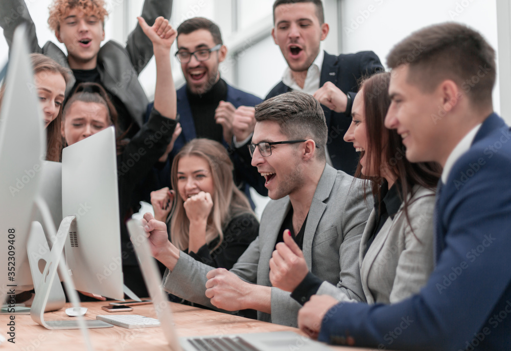 jubilant business team looking at the computer monitor jubilant business team looking at the computer monitor