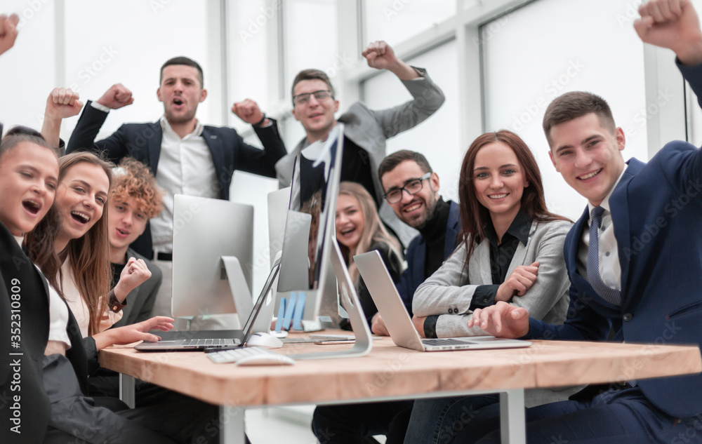 group of happy office employees sitting at a table. group of happy office employees sitting at a table.