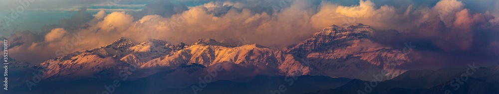 Plakat beautiful panoramic of the los andes mountains and clouds in the sky (Santiago, Chile)