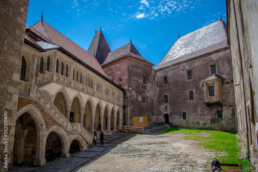 The inner courtyard of a castle in Romania. Corvin Castle, also known as Hunyadi Castle. Hunedoara, Romania. May, 23, 2020