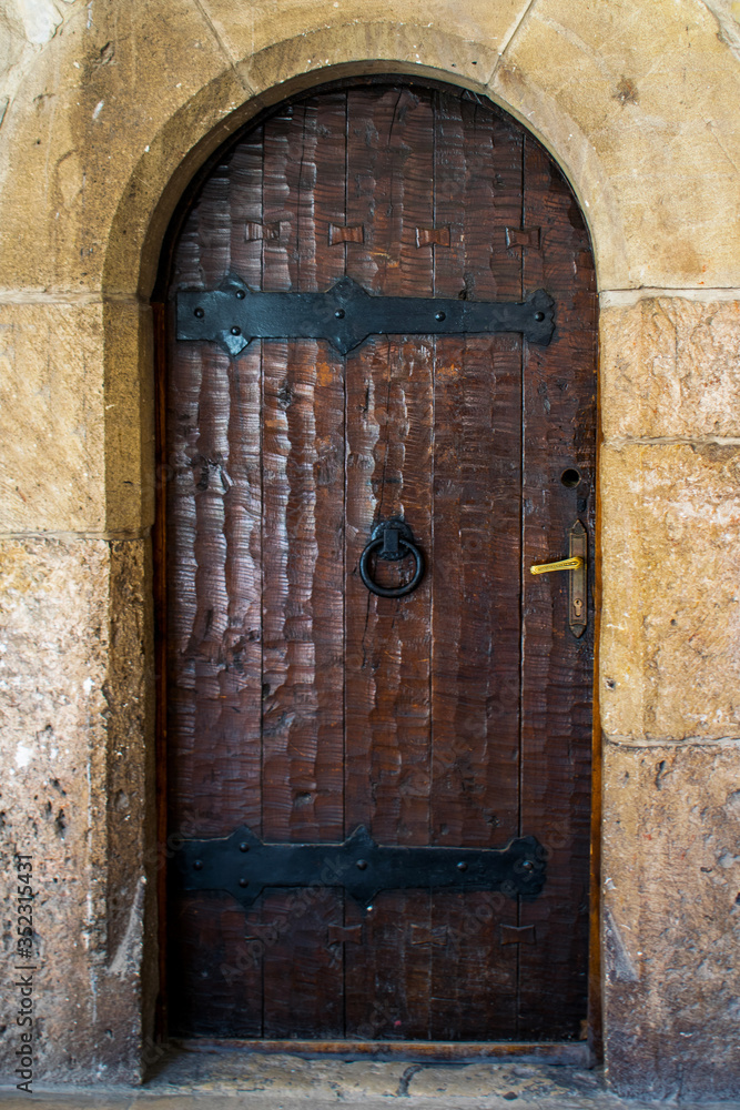 Old wooden door at the entrance to a medieval castle in Romania