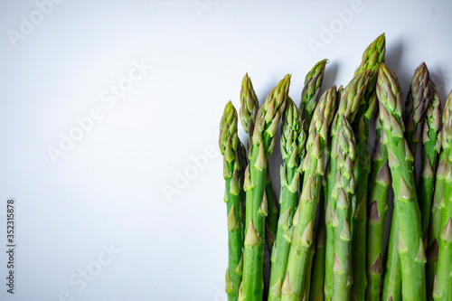 Fresh sprouts of asparagus isolated on white background. Fresh green asparagus on white. Asparagus. Raw asparagus. Fresh Asparagus.Green Asparagus.