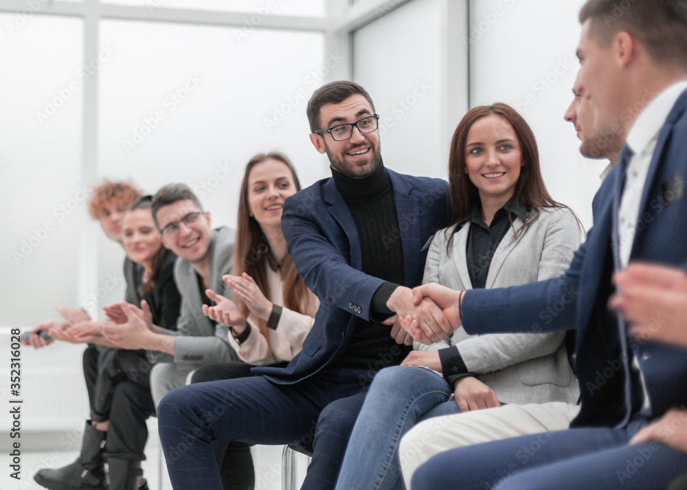 business people shaking hands to the applause of the business team business people shaking hands to the applause of the business team
