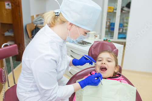 Little girl in dentist's clinic treat tooth. Healthy lifestyle, medicine concept