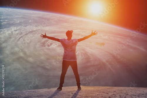 Billede på lærred man with open arms facing a universe silhouette at the sunset
