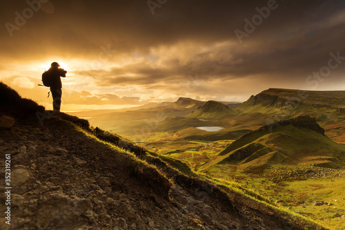 Scenic view of Quiraing mountains in Isle of Skye  Scottish highlands  United Kingdom. Sunrise time with colourful an rayini clouds in background.