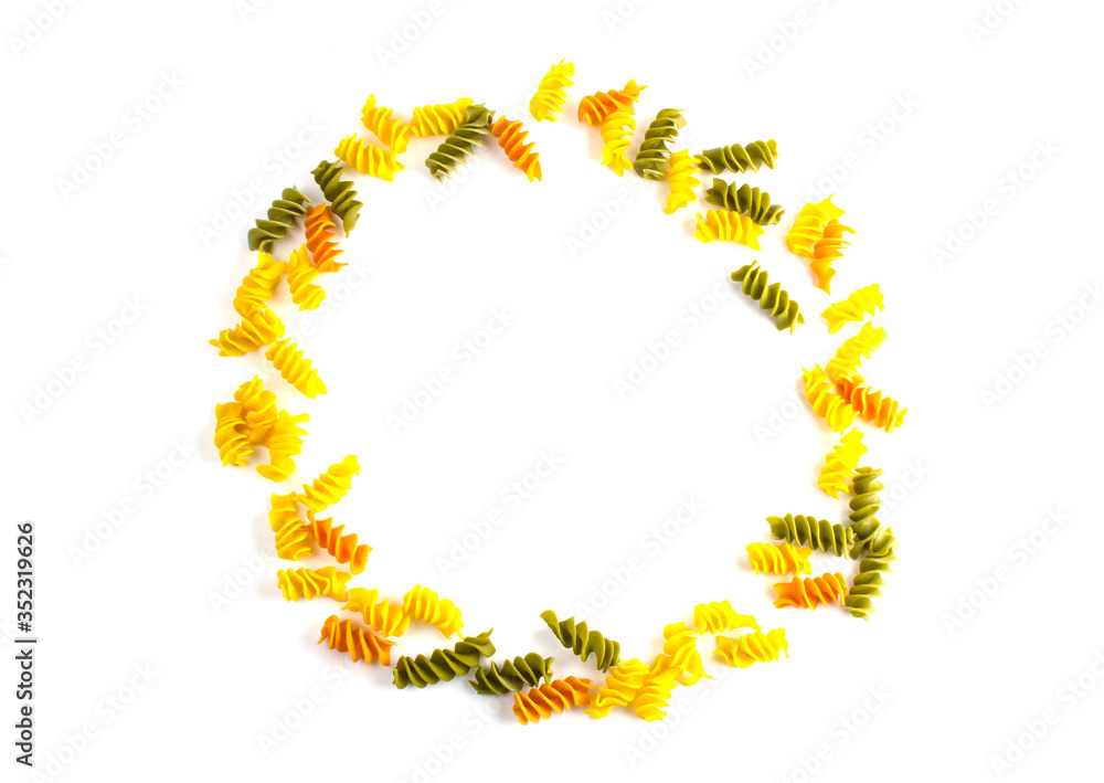 Obraz premium uncooked colored pasta lined around on a white background