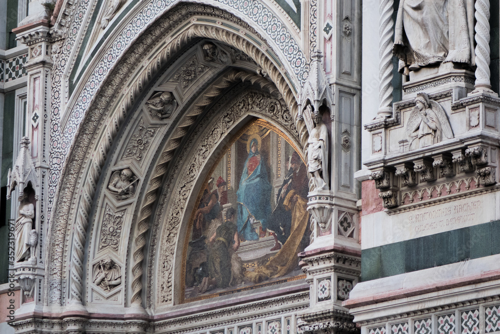 Exterior / facade of the Cathedral of Santa Maria del Fiore in Florence, Italy. Close shot of decoration and art of the front fasade of the cathedral