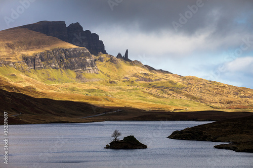 Loch Leathan and Old man of Storr rock formations, Isle of Skye, Scotland. Concept: typical Scottish landscape, tranquility and serenity, particular morphologies. photo