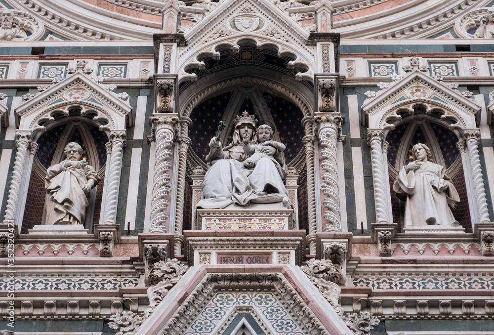 Exterior / facade of the Cathedral of Santa Maria del Fiore in Florence, Italy. Close shot of decoration and art of the front fasade of the cathedral