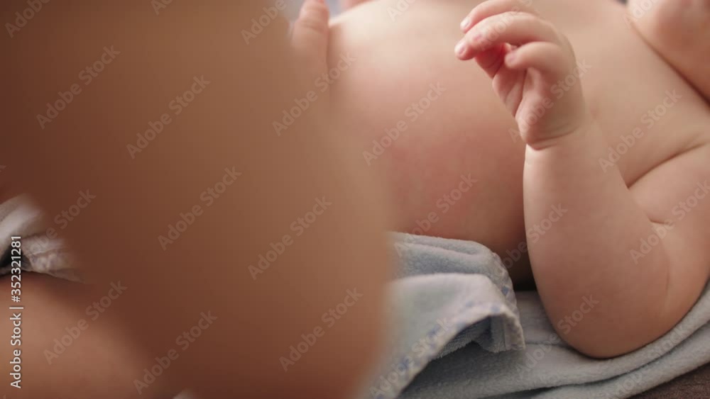 Close up. Mother tapping, massaging babys tummy. Baby care concept Close up. Mother tapping, massaging babys tummy. Baby care concept