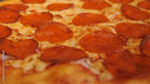 Pepperoni pizza rotates close-up. Delicious footage for the menu of pizzerias and restaurants.