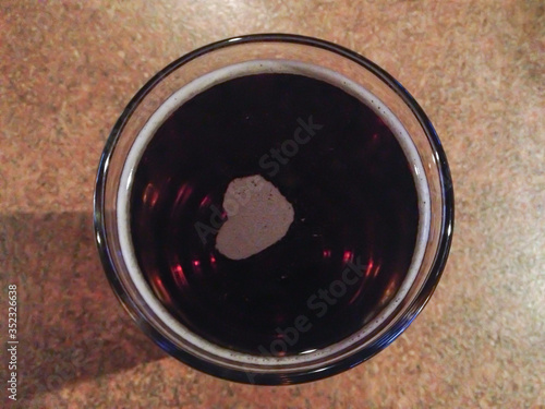 close up of dark beer with heart photo