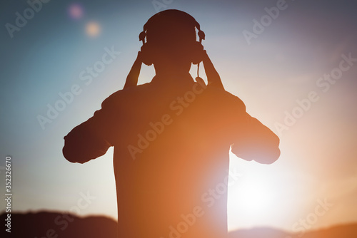 stylish bearded man in headphones listening to music