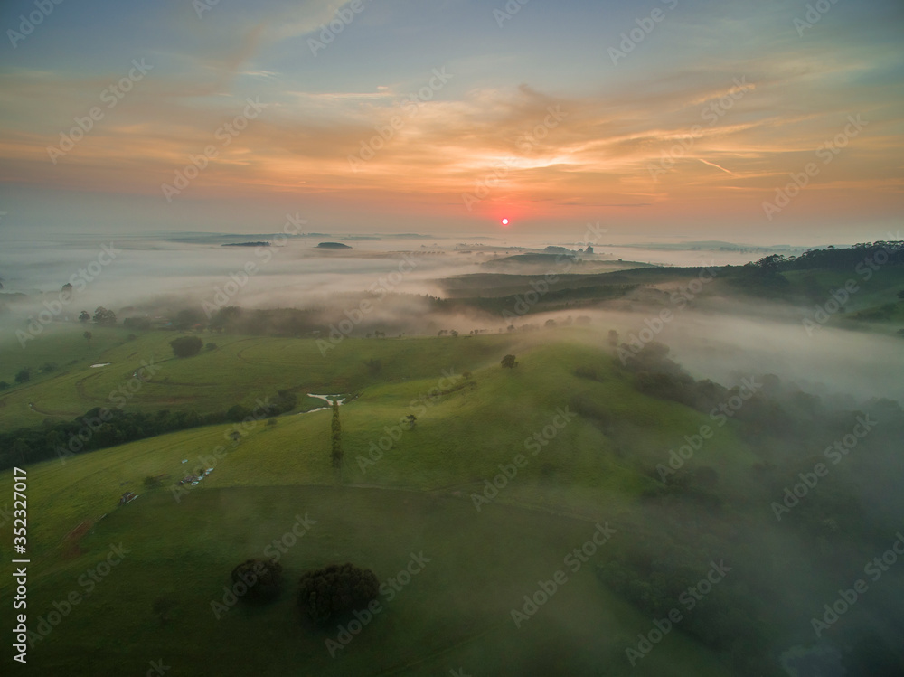 Sunrise above the Clouds at Contryside with the Sun at the Horizon.