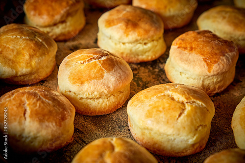 Closeup of freshly prepared english scones on tray with powder