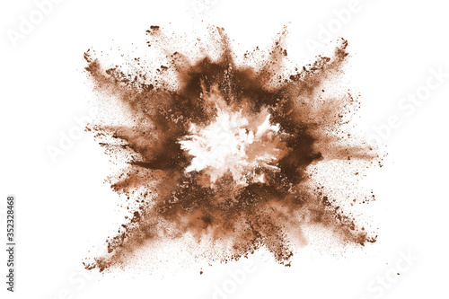 Brown color powder explosion on white background. Colored cloud. Colorful dust explode. Paint Holi.