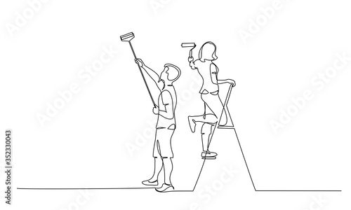 Couple man and woman painting the wall using roller stick